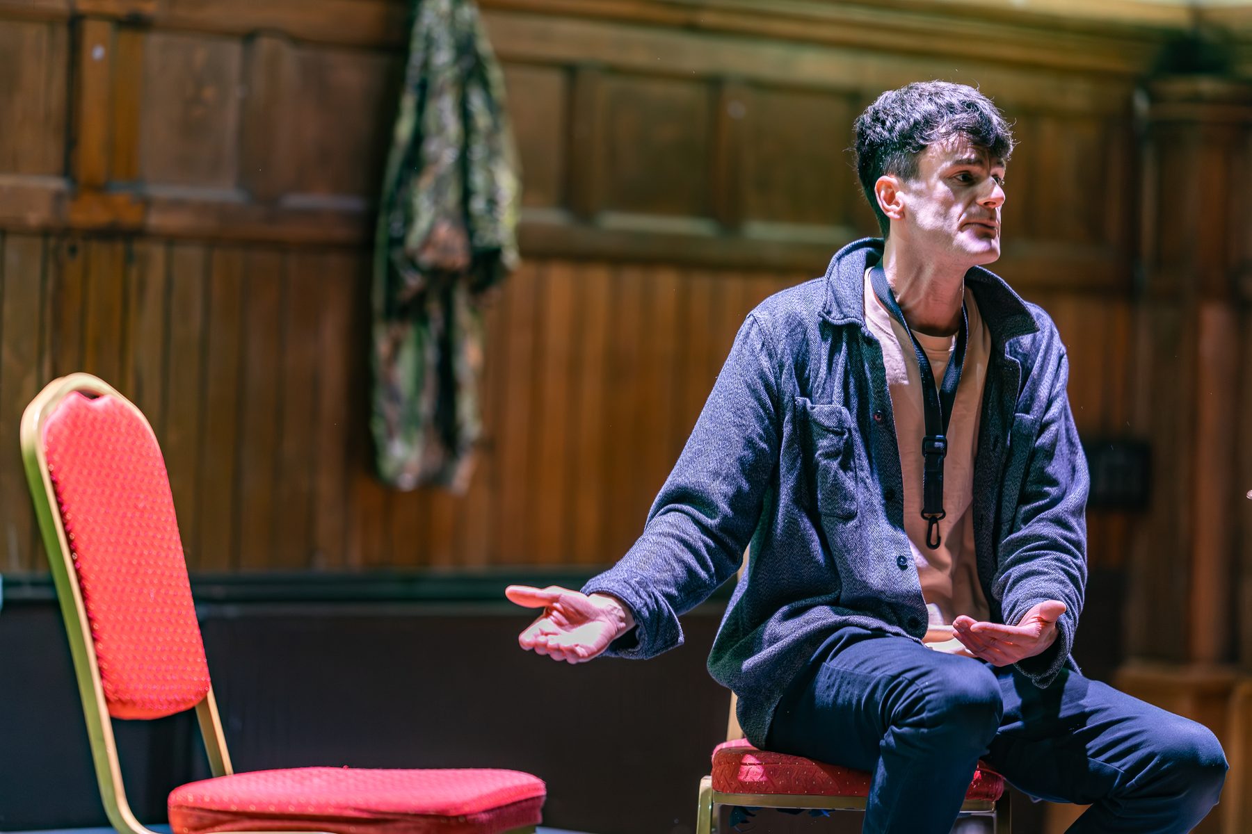 Tom Rigby acting — seated, mid-scene